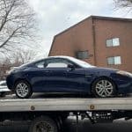 2008 Mazda sitting on the back of the Cash 4 Cars flatbed truck, purchased in Chili, NY.